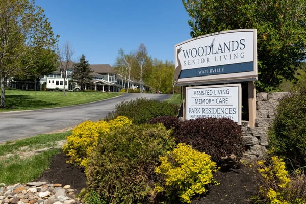 Exterior view of Woodlands Senior Living sign and building