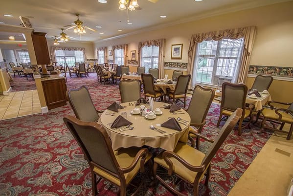 Dining room set for a meal at a senior living facility