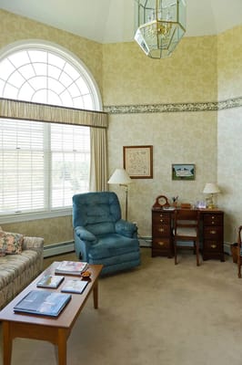 Cozy common area with a blue recliner and a desk