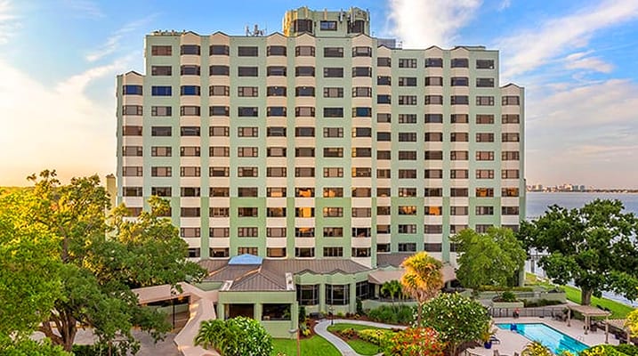 Exterior view of a senior living facility with gardens
