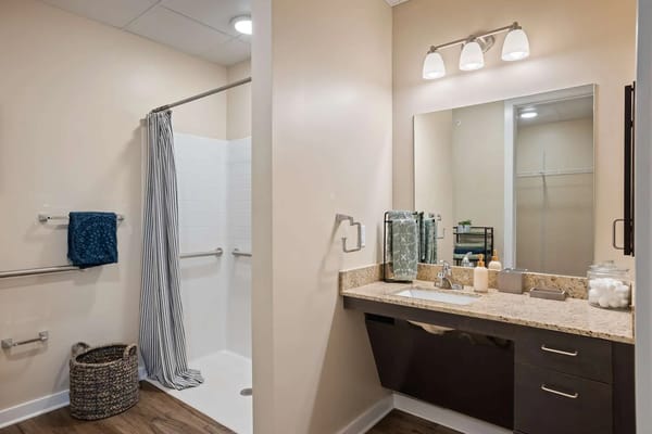 Well-lit bathroom with shower and vanity