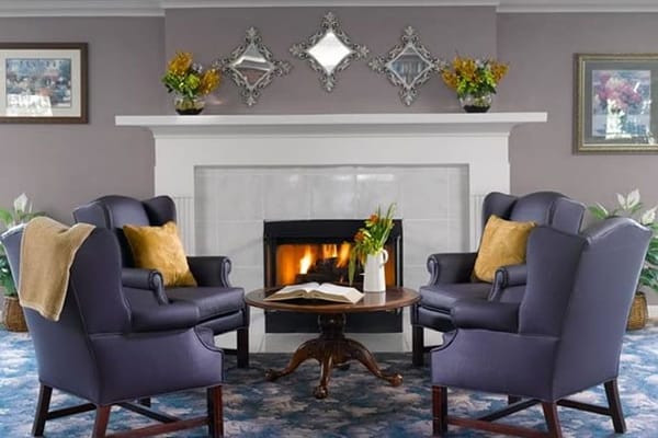 Cozy common area with chairs and fireplace