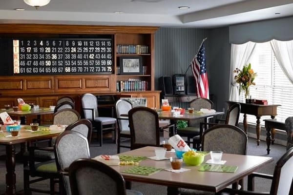 Dining area with tables and bingo board in the background