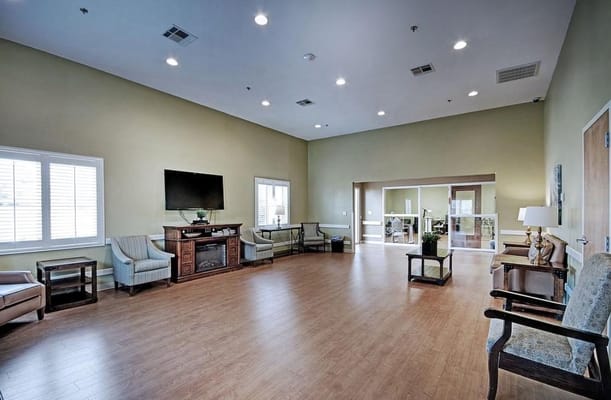 Spacious common area with seating and television