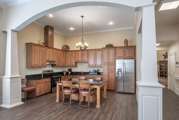 Bright kitchen area with wooden cabinets and seating