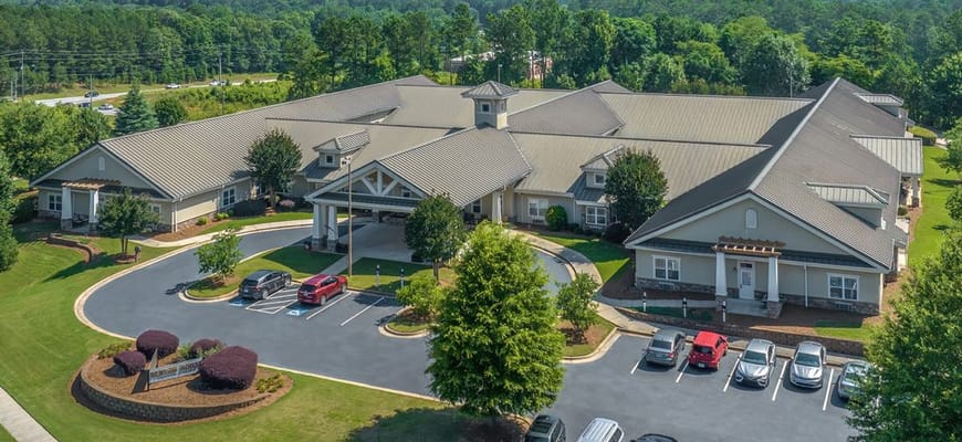 Aerial view of a senior living facility with landscaped grounds