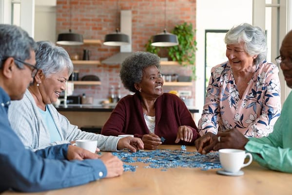 Residents enjoying a puzzle activity in a common area