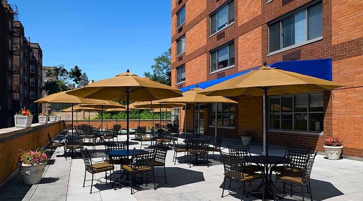 Outdoor patio area with large umbrellas and tables