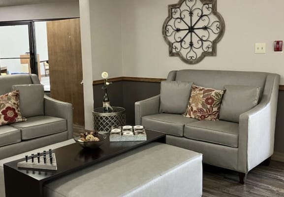 Common area with seating and decor in a senior living facility