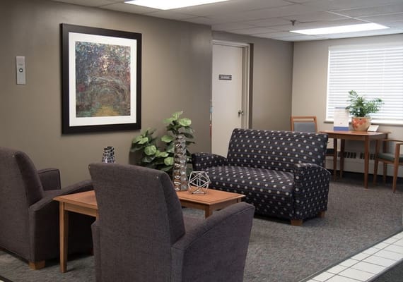 Lounge area with seating and artwork at Franklin Plaza Extended Care