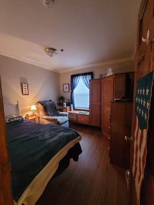 Cozy private bedroom with furniture and natural light