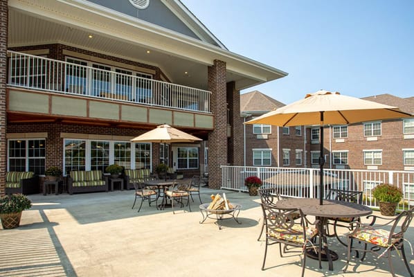 Spacious outdoor patio with seating and umbrellas at Magnolia Springs Florence.