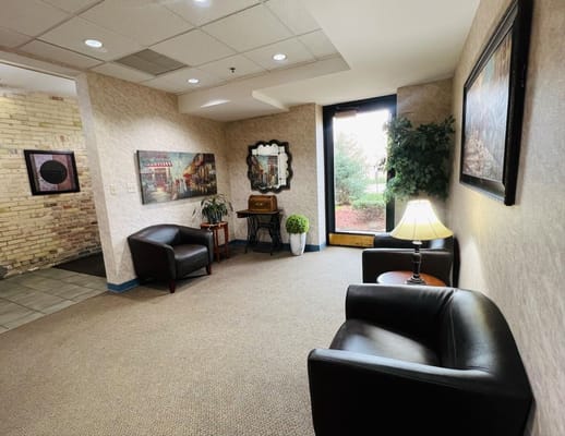 Cozy lounge area with seating and artwork