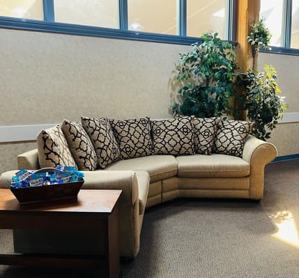 Cozy common area with a sectional couch and plants