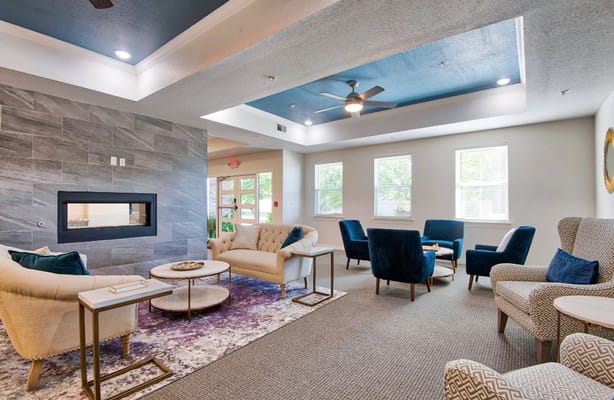 Bright common area with comfortable seating and a fireplace