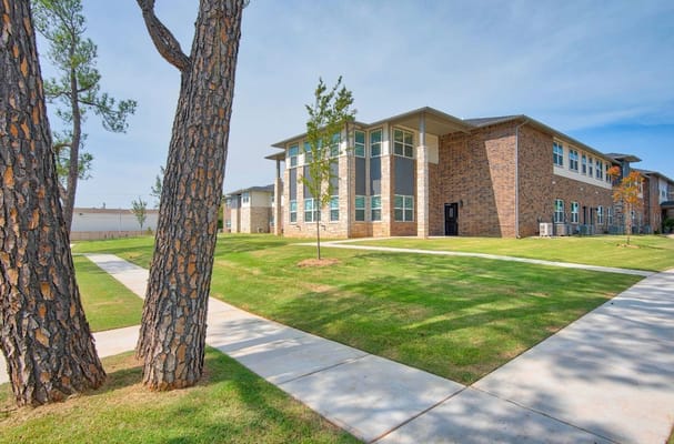 Exterior view of a senior living facility with green landscaping