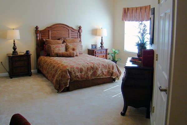 Cozy bedroom with floral bedding and lamps