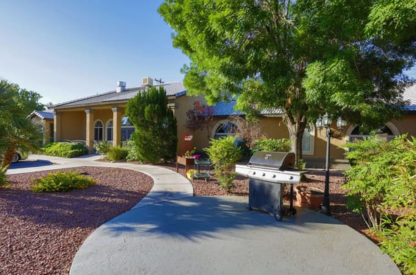 Exterior view of a senior living home with landscaped path