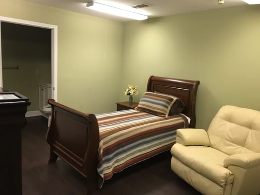 Interior view of a private resident room with furniture