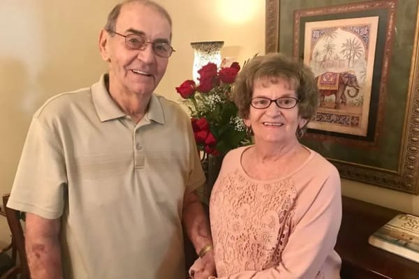 Two residents smiling together in a cozy interior