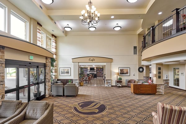 Welcoming lobby area with seating and café entrance