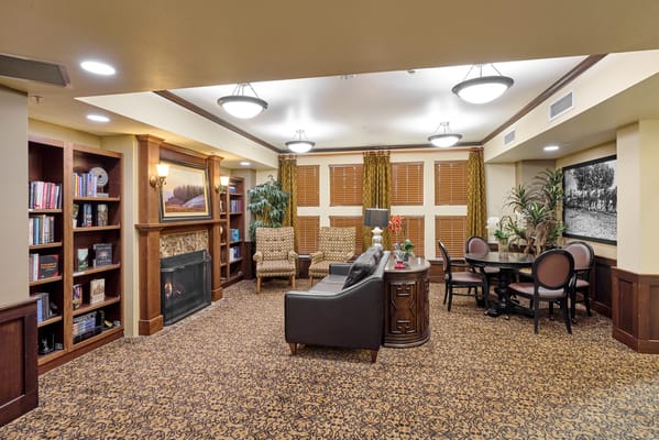 Cozy common area with seating, books, and fireplace