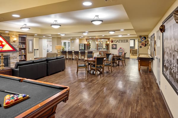 Interior view of a lively common area with seating and games