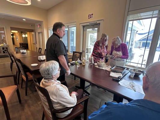 Residents participating in a cooking activity in the common area