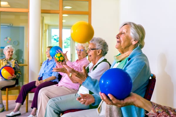 Residents participating in a therapeutic ball activity