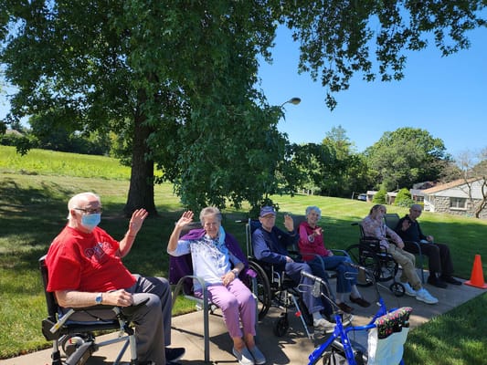 Residents enjoying time outdoors and waving