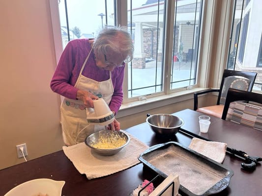 A resident baking in a sunny kitchen