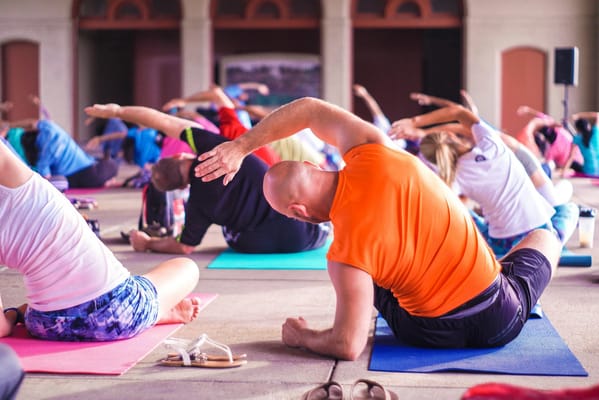 Residents participating in a group yoga activity indoors