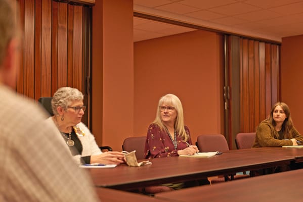 Meeting with staff in a brightly lit room