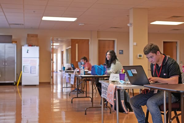 Residents and staff engaged in activities at tables