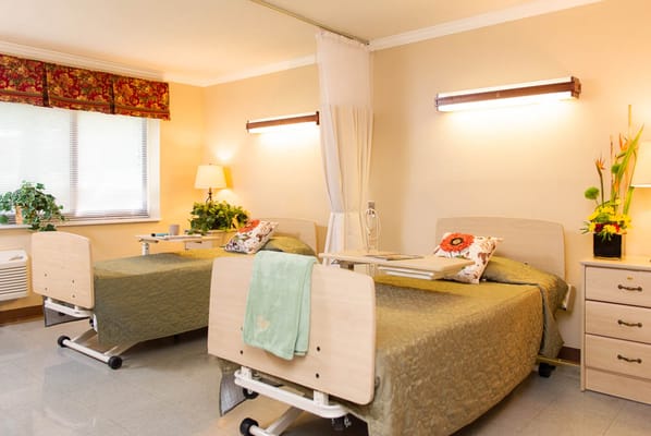Comfortable resident room with two beds and decor
