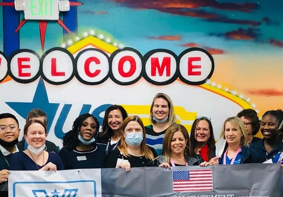 Staff members posing in a vibrant activity room