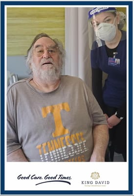 Resident with staff member in a care facility