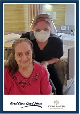 A caregiver and resident interacting in a room