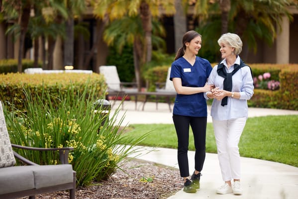 Staff member assisting a resident in the garden