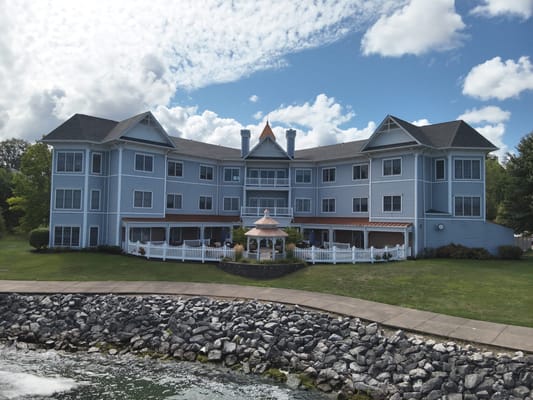 Exterior view of a senior living facility by the water