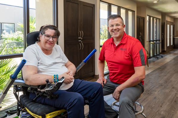 Staff member with resident in a hallway