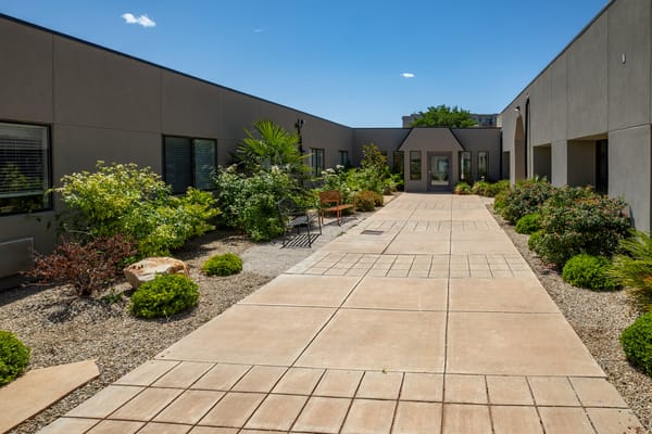 Pathway through landscaped outdoor area of the facility