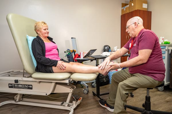 Therapist providing care to a resident in a treatment room
