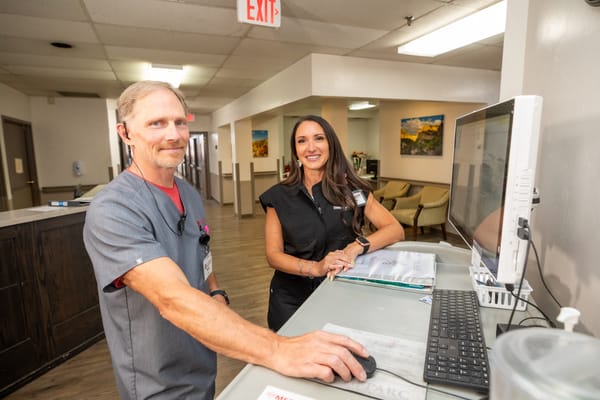 Staff members at a reception desk in the facility