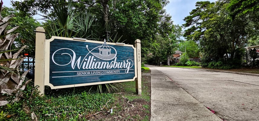 Signage for Williamsburg Senior Living Community on a tree-lined street