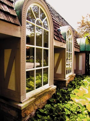 Exterior view of building with large windows and landscaping