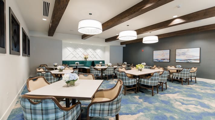 Bright dining room with tables and floral arrangements