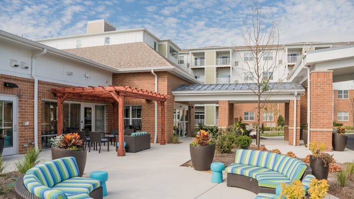 Outdoor seating area with vibrant furniture and landscaping