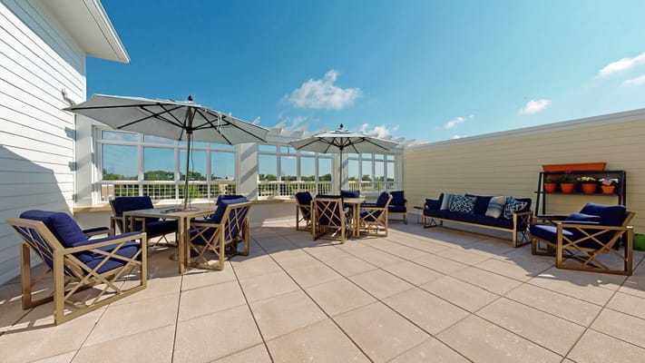 Outdoor patio area with seating and umbrellas