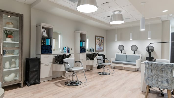 Hair salon area with styling chairs and mirrors